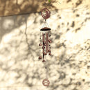 a wind chime hanging on a tree